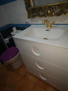 a bathroom with a white sink and a toilet at Puerto de Mogan Sonneland in Puerto de Mogán