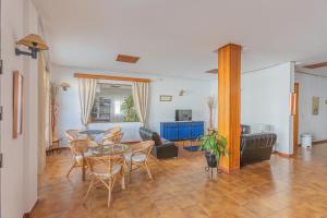 a living room with a table and chairs at Hotel Tres Jotas Conil in Conil de la Frontera