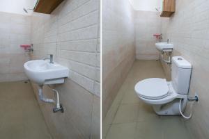 a bathroom with a toilet and a sink at FabExpress KP Suites Villas in Turkapally