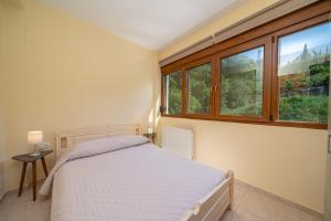Posteľ alebo postele v izbe v ubytovaní Mariel House Fiskardo Kefalonia