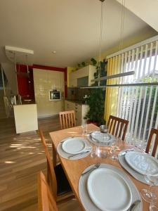 a dining room with a table with white plates on it at Hartweger House in Kaprun