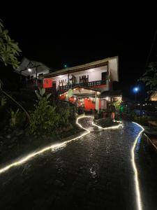 a building at night with lights on the street at Garden Grove Guest House & Coffee Bar in Bukit Lawang