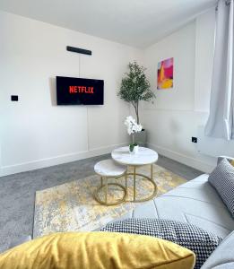 Luxury Norwich City Centre Apartment - Free Parking في نورويتش: غرفة معيشة مع أريكة وطاولة