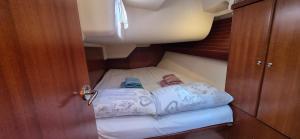 a small room with a bed and two pillows at Trifula in Cagliari