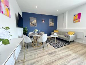 a living room with a table and a couch at Luxury Norwich City Centre Flat - Free Parking in Norwich