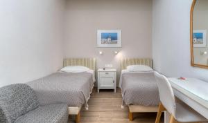 A bed or beds in a room at Manto Hotel