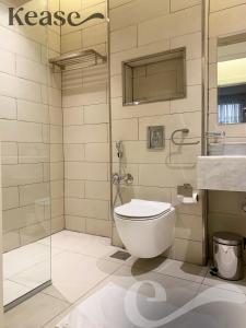 a bathroom with a toilet and a shower at Kease Tawun A1-8 Royal touch Balcony GZ41 in Riyadh