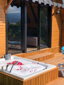 une baignoire avec des pétales de roses rouges sur une terrasse dans l'établissement EYLÜL BUNGALOV, à Aşağıkaraman