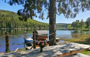 a dock with a boat on a lake at Nice Home In Bollstabruk With House Sea View in Bollstabruk