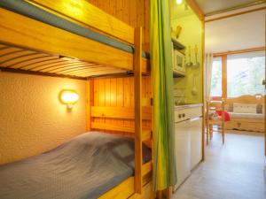 a bedroom with two bunk beds and a kitchen at Studio Les Arcs 1800, 1 pièce, 3 personnes - FR-1-346-473 in Arc 1800