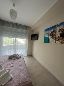 a bedroom with a bed and a tv on a wall at Appartamenti Tropea Middle Town in Tropea