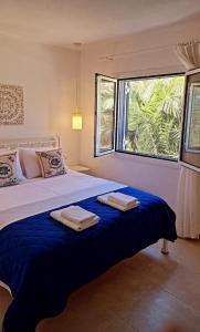 a bedroom with a large bed with two towels on it at Diana's Luxury Suites in Kithnos