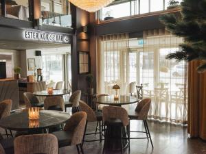 restauracja ze stołami, krzesłami i oknami w obiekcie Best Western Plus John Bauer Hotel w mieście Jönköping