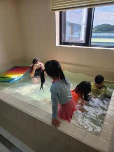 a group of children playing in a bath tub at Hound Hotel Gijang Osiria in Busan