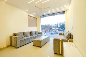 uma sala de estar com um sofá e uma mesa em FabHotel The Luxe Inn em Nova Deli