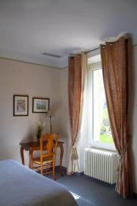 Postel nebo postele na pokoji v ubytování Le Relais Notre Dame