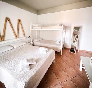 two beds in a room with two bunk beds at Boutique Mare in Galissas