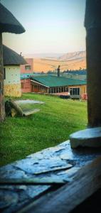 a view of a building with a field of grass at Sobantu Guest Farm in Piggs Peak +12 photos