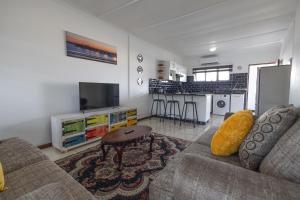 a living room with a couch and a table at Safi Luxury Self-Catering Suite 8 in East London