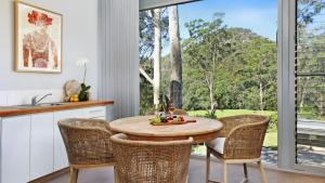 a kitchen with a table and chairs and a window at Saltwater Creek - The Birds Nest in Bundannon
