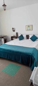 a bedroom with a large bed with a blue blanket at Pensiunea Crai Nou in Şirnea