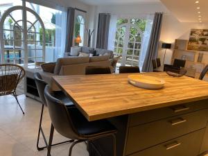 a kitchen and living room with a table and chairs at Villa face mer in Royan
