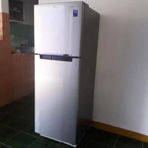 a white refrigerator sitting in a kitchen at KJ Purple House Senggigi in Senggigi