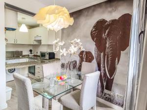 a dining room with an elephant mural on the wall at Rentaliday Vip Rooms in Adeje