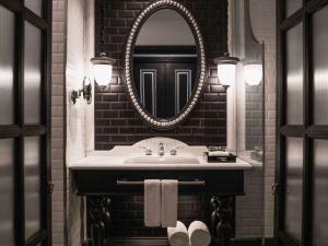 a bathroom with a sink and a mirror at Hotel de la Coupole - MGallery in Sa Pa