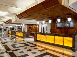 a lobby of a hotel with a reception counter at Swissotel Al Maqam Makkah in Mecca
