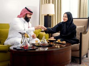 a man and a woman shaking hands in a room at Swissotel Al Maqam Makkah in Mecca +37 photos