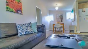 a living room with a couch and a table at Catho Cottage in Catherine Hill Bay