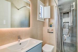 a bathroom with a sink and a toilet and a shower at Paros Sea View Eco - Aetherian Ciel Villas, Alia in Mármara +28 photos