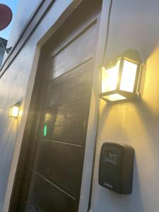 een deur met een licht aan de zijkant van een huis bij House In Subdivision- Lapu-Lapu City Near Airport and CCLEX in Lapu Lapu City