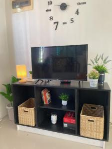 a black entertainment center with a tv on top at House In Subdivision- Lapu-Lapu City Near Airport and CCLEX in Lapu Lapu City