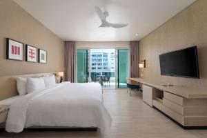 a bedroom with a large bed and a television at Wyndham Grand Barbados Sam Lords Castle All Inclusive Resort in Saint Philip