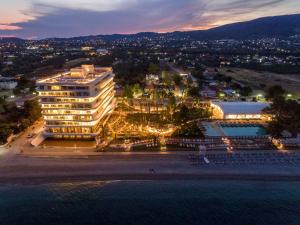 an aerial view of a hotel at night at Isla Brown Corinthia Resort & Spa, Curio Collection by Hilton in Agioi Theodoroi