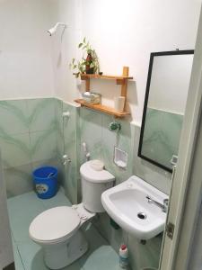 a bathroom with a toilet and a sink and a mirror at House In Subdivision- Lapu-Lapu City Near Airport and CCLEX in Lapu Lapu City
