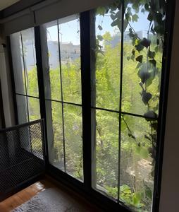 a room with a window looking out at a field at Luxury Apartment Palermo Hollywood in Buenos Aires