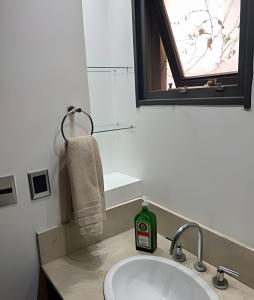 a bathroom sink with a bottle of soap on it at Luxury Apartment Palermo Hollywood in Buenos Aires