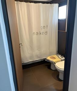 a bathroom with a toilet and a shower curtain at Luxury Apartment Palermo Hollywood in Buenos Aires +21 photos