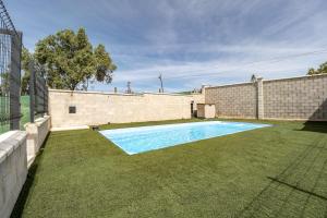a swimming pool in the yard of a house at Casa rural Montemayor in Moguer