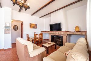 a living room with two couches and a fireplace at Casa rural Montemayor in Moguer