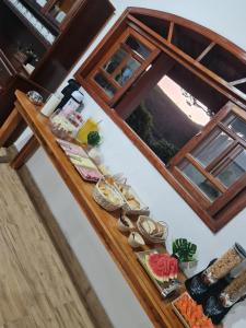a table with food on it with a window at Chalé Barco Recanto Buscapé SFX in São Francisco Xavier