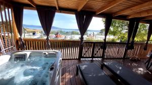 a hot tub on a deck with a view at MOBILE HOMES SELCE - Alpe Jadran MOBIL in Selce