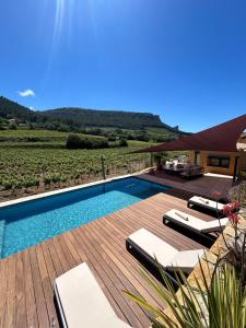 a villa with a swimming pool with a view of a vineyard at Côté vignes cassis in Cassis