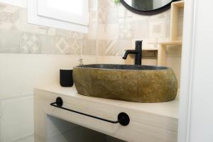 a bathroom with a stone sink on a counter at Saint Jack Luxury in Trieste +21 photos