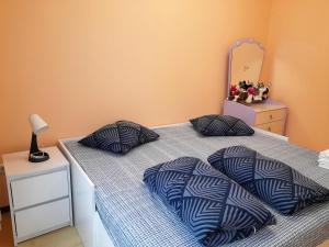 a bedroom with two beds with pillows and a mirror at Apartament Dzintari in Jūrmala
