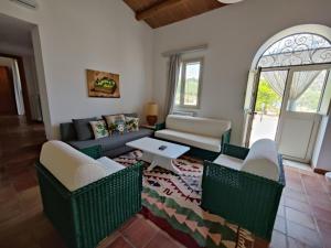 a living room with a couch and chairs and a table at Casa Titì in Cefalù