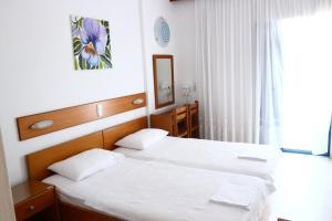 Postel nebo postele na pokoji v ubytování Danae Hotel
